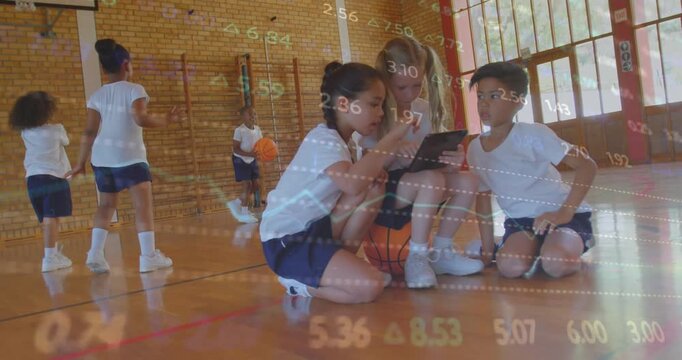 Three students tapping tablet in PE class with basketball initiating data view with floating charts
