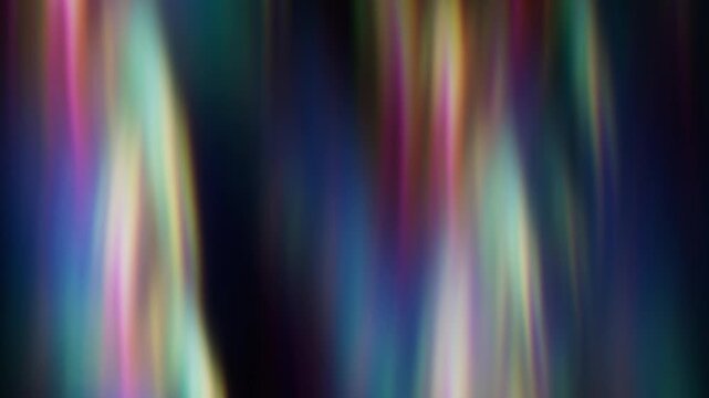 Abstract dark background vertical rainbow light streaks. Prismatic spectrum colors flowing through shadows. Cinematic motion blur texture video backdrop. Creative light leaks.