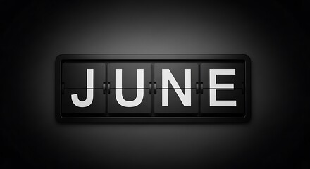 Black and white flip calendar displays "JUNE" against a dark background, in focus