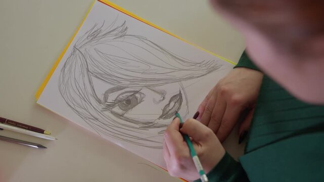 An Artist Skillfully Sketches Vivid Human Portrait Using Various Instruments. Talented Creator Meticulously Crafts Detailed Face Portrait Accompanied By Drawing Implements And Materials