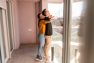 Fototapeta premium Young Couple Embracing On Balcony