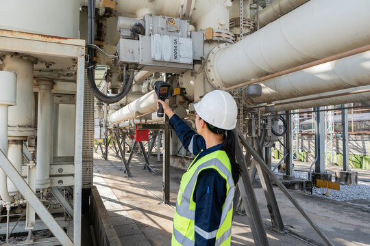 Engineer performs electrical safety inspection with a thermal camera on high voltage equipment, checking connections and surfaces to improve reliability, diagnostics, and maintenance.