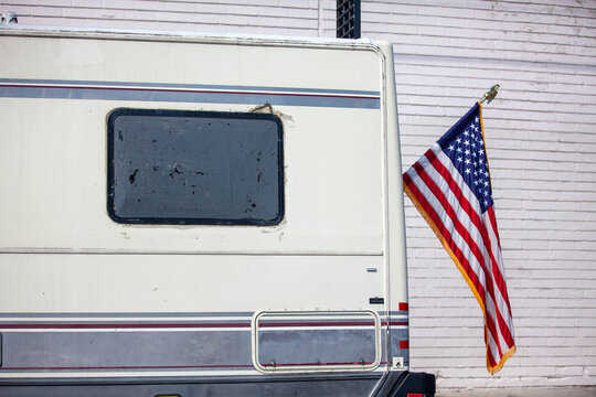 Clean American flag on a battered RV