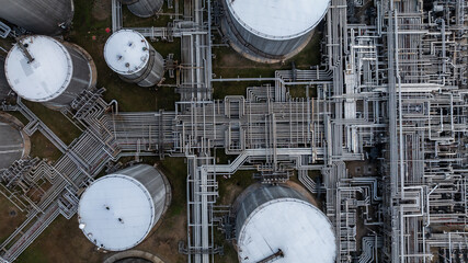 Aerial view white oil storage tank with pipeline steel, Crude oil industry, Storage fuel gas container tank petroleum refinery industrial factory, Oil storage chemical petrochemical refinery product.