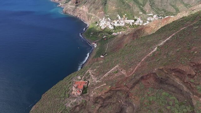 View from the cliff to the village of Igueste in Tenerife, Canary Islands. In the foreground, an abandoned semaphore station. In the background, Las Teresitas beach, San Andres, Santa Cruz.