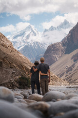 Friends hugging admiring snow capped mountains on baltoro trek. Baltoro