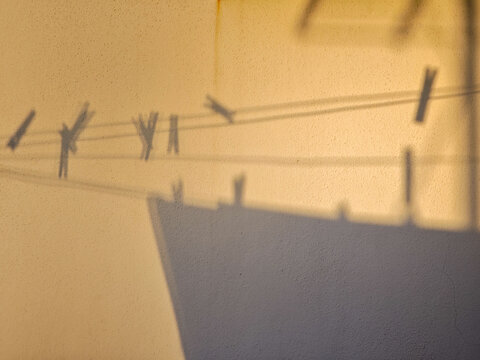 Seville Sunset: Clothesline, Clothespin Shadows on Whitewashed Wall