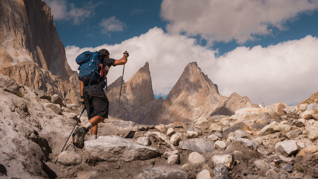 Hiker trekking baltoro glacier with trango towers view. Paiju koburtse