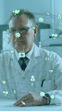 Vertical video: Senior doctor viewing medical overlay appearing, tapping heart, pill to review data