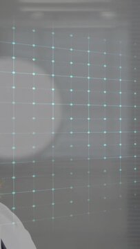 Vertical video: Neon ECG line rising on holo grid revealing senior doctor face, monitoring vitals