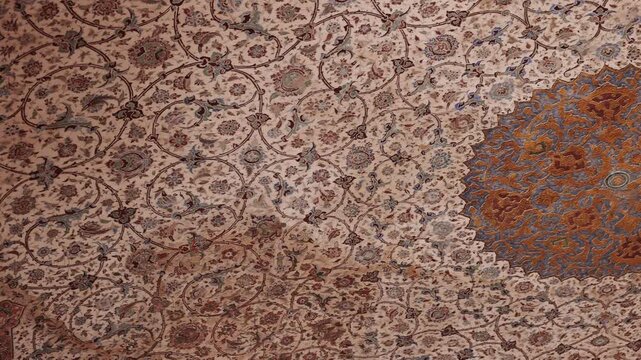 Painted ceiling with blue tile patterns inside Imam Mosque at Naqsh e Jahan Square in Isfahan Iran, UNESCO World Heritage Site. Detailed Persian Islamic architecture with traditional mosaic tiles 