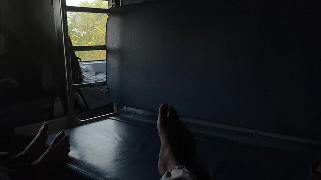 Traveling in Indian train, small window visible scenes passing low light