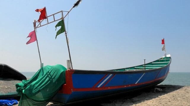 The colorful flags on the fishing boat flutter in the wind
