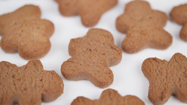 Decorative display featuring intricately designed gingerbread shapes. Showcase of elaborately patterned baked gingerbread figures emphasizing detailed textures and cozy appeal