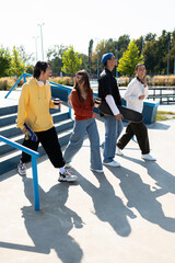 Young friends enjoying a sunny day of skating and laughter at the park