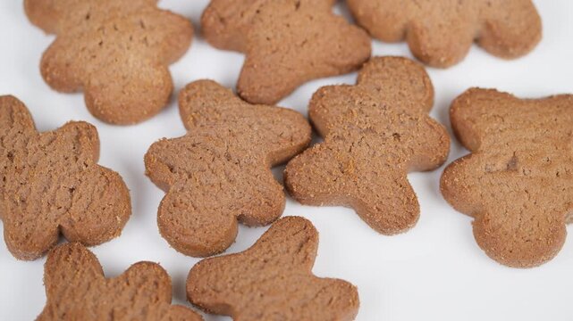 Assorted crunchy gingerbread shapes arranged for holiday presentation. Varied silhouettes of gingerbread cookies with vibrant studio illumination suitable for packaging