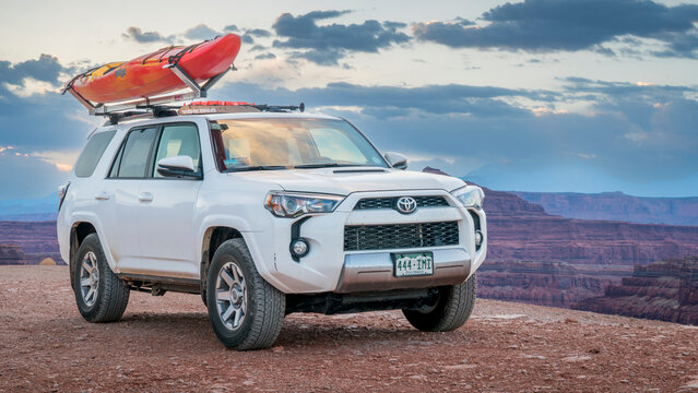 Potash, UT, USA - May 7, 2017: Toyota 4runner SUV  with a whitewater kayak on roof racks in the Colorado RIver canyon near Moab.