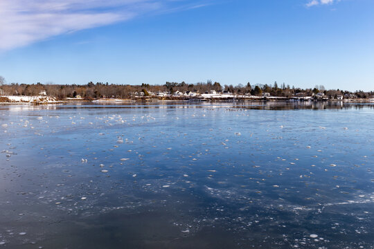 Wide view of the waterfront homes at Searsport Maine on Penobscot Bay in the winter.