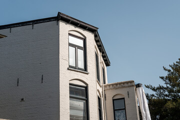 Dutch building facade with white bricks and arched windows