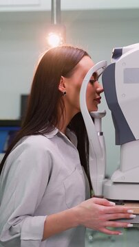 Woman receiving an eye examination with an autorefractor keratometer
