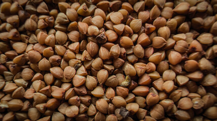 Buckwheat groats texture photographed from above. Natural raw cereal grain background suitable for healthy eating, organic food concepts, cooking ingredients and rustic kitchen themes.