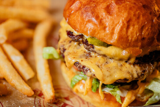 A double cheeseburger with french fries at a modern American restaurant