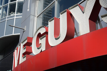 Naklejka premium close-up of sign on the front of Five Guys, a fast food restaurant, located here at 329 Yonge St, Toronto