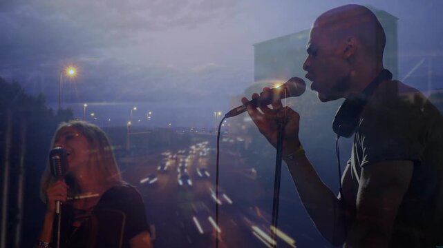 Projector casting music set while male singer duetting with female, mic and traffic moving for duet