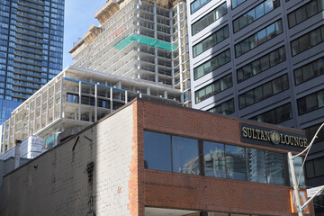 Obraz premium exterior of buildings including a sign for Sultan Lounge, a hookah bar, located at 171 Dundas St W (view from Chestnut St), Toronto