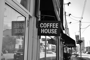 Obraz premium wall mounted projecting sign outside Haute Coffee, an espresso bar, located at 153 Dupont St, Toronto