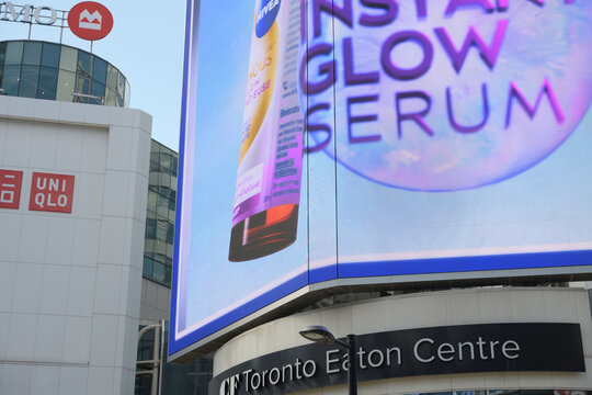 oversized electronic advertisement for Nivea Luminous630 Skin Glow Serum above entrance to CF Toronto Eaton Centre, Sankofa Square