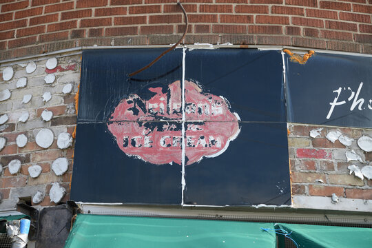 vintage mid-century painted storefront sign of Neilson's Ice Cream on the front of Convenience / kiosco at 342 Donlands Av, East York, Toronto