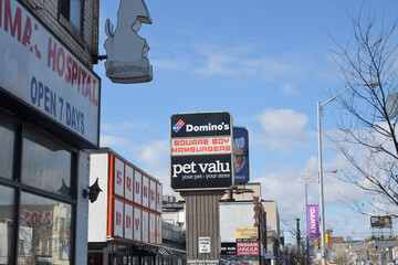 Naklejka premium roadside pylon sign with Domino's Pizza, Square Boy restaurant, and Pet Valu, pet supply store, Danforth Av, Toronto