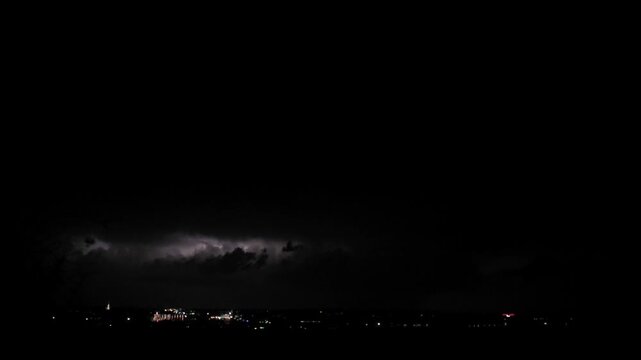 Dramatic foreboding spooky lightning strikes over a cityscape