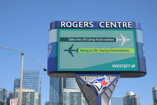 Rogers Centre Gardiner LED pylon sign with advertising for WestJet and Toronto Blue Jays logo
