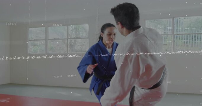 White gi initiating kick, blue gi gripping and throwing for martial arts training on red mat