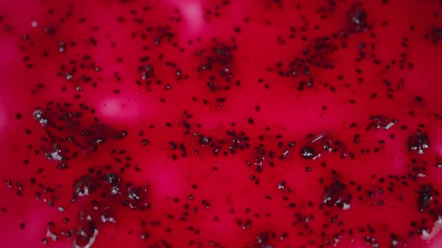 Closeup of colorful fruit preserve. Detailed macro image of shiny berry jam spread. Highmagnification shot showcasing shimmering waxy exterior of fresh berry jelly spread
