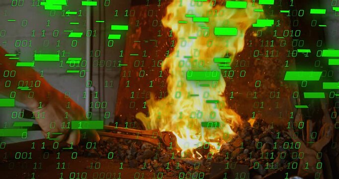 Smith using tongs placing metal into coals, causing flame, green overlay covering fire for forging