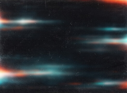 Vintage anamorphic lens flare with cyan and red light leaks on black background