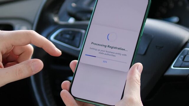 Close up of hands using a smartphone app to register a new business organization while sitting in a car. Entrepreneur forming an LLC online. Concept of mobile startup, digital nomad lifestyle, and