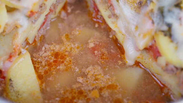Delicious baked meat and potato. Filling dish with savory meat and cheese. Robust and flavorful casserole combining tender meat with cheesy potatoes for complete satisfaction