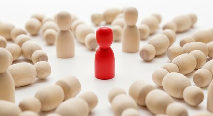 Red wooden peg standing within a circle of fallen plain pegs perfect for business survival competitive winning and inner strength