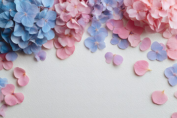 Obraz premium Pastel Blue and Pink Hydrangea Petals Framing Blank Textured Paper — Romantic Floral Flatlay for Greeting Cards and Invitations