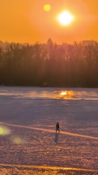 Beautiful sunset view of Kyiv in winter with frozen Dnipro River