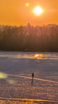 Beautiful sunset view of Kyiv in winter with frozen Dnipro River