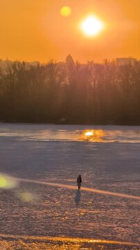Beautiful sunset view of Kyiv in winter with frozen Dnipro River