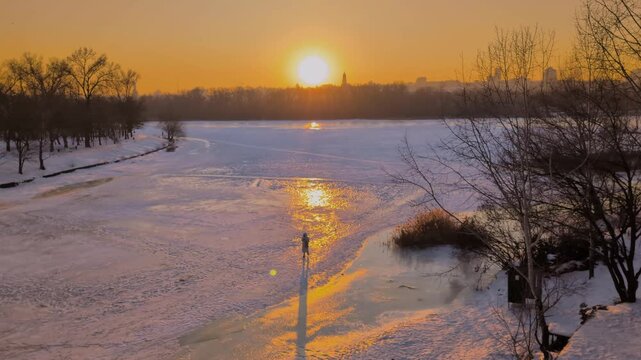 Beautiful sunset view of Kyiv in winter with frozen Dnipro River