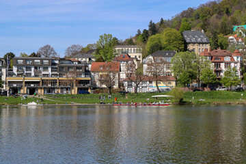 Obraz premium Picturesque view of the Neckar River and the embankment of Heidelberg, Germany