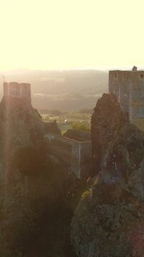 Trosky Castle aka Hrad Trosky aerial sunset view. Famous landmark, one of the main symbols of the Bohemian Paradise. Tourist destination popular for its romantic atmosphere and unique exterior.