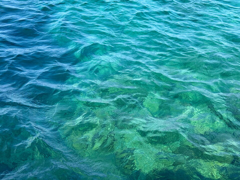 Ocean waves blue clear waters background.